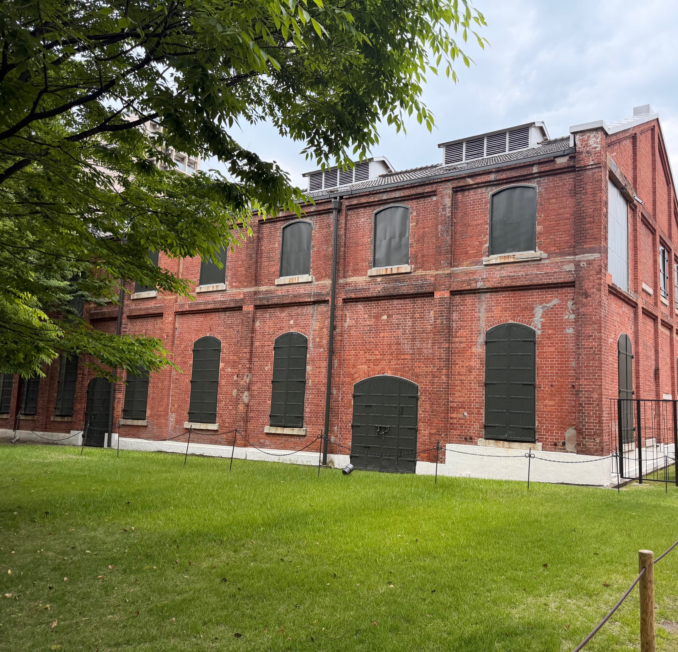 Red-brick facade with dark iron shutters